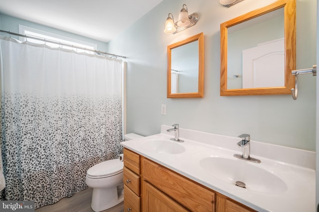 bathroom featuring walk in shower, vanity, toilet, and hardwood / wood-style floors