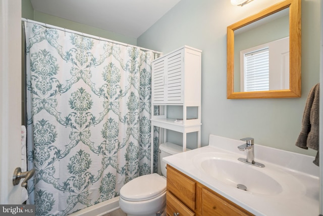 bathroom featuring vanity, toilet, and a shower with shower curtain