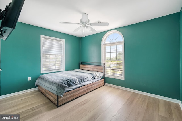 bedroom with ceiling fan and light hardwood / wood-style flooring