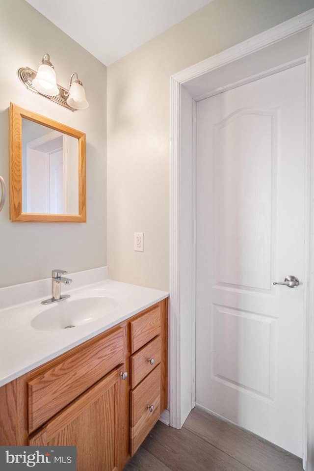 bathroom with vanity and hardwood / wood-style floors