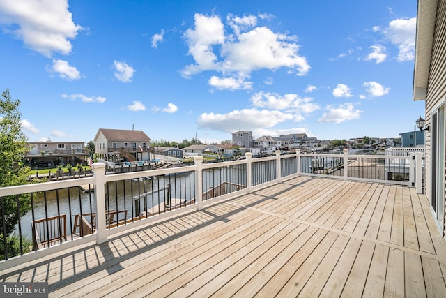 wooden terrace featuring a water view