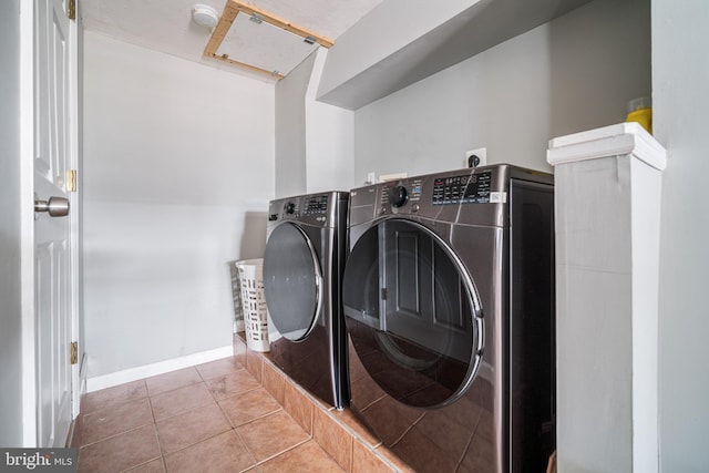 laundry area featuring light tile patterned flooring and washer and dryer