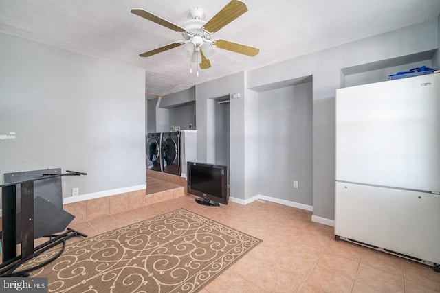 tiled living room featuring washer and clothes dryer and ceiling fan