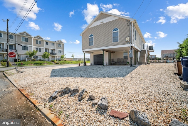 back of house featuring a garage