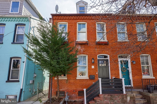 townhome / multi-family property with brick siding