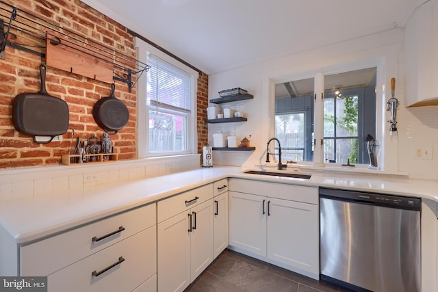 kitchen with white cabinets, dishwasher, light countertops, open shelves, and a sink