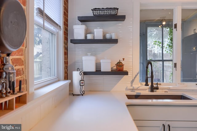 bar featuring a sink and a wealth of natural light