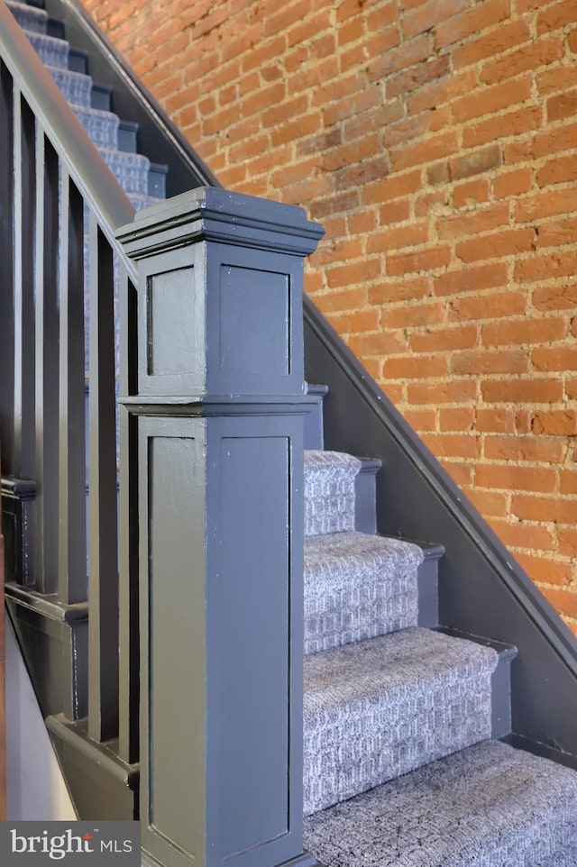 staircase with brick wall