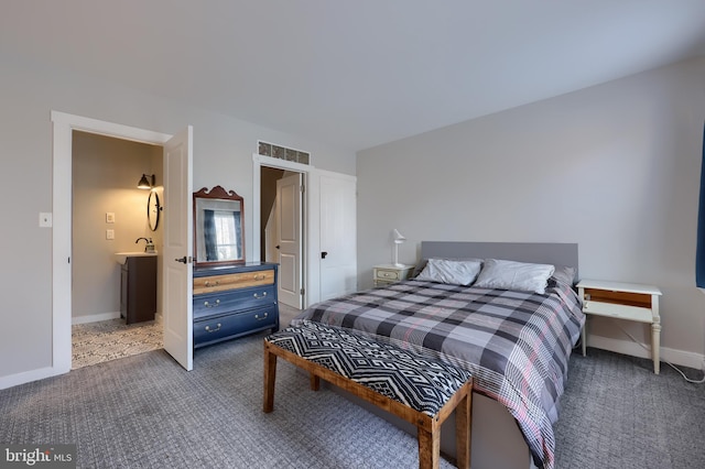 bedroom featuring light colored carpet, a sink, and baseboards