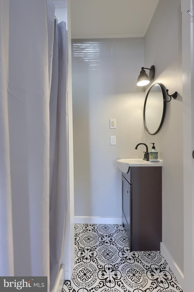 full bath with baseboards, vanity, and tile patterned floors