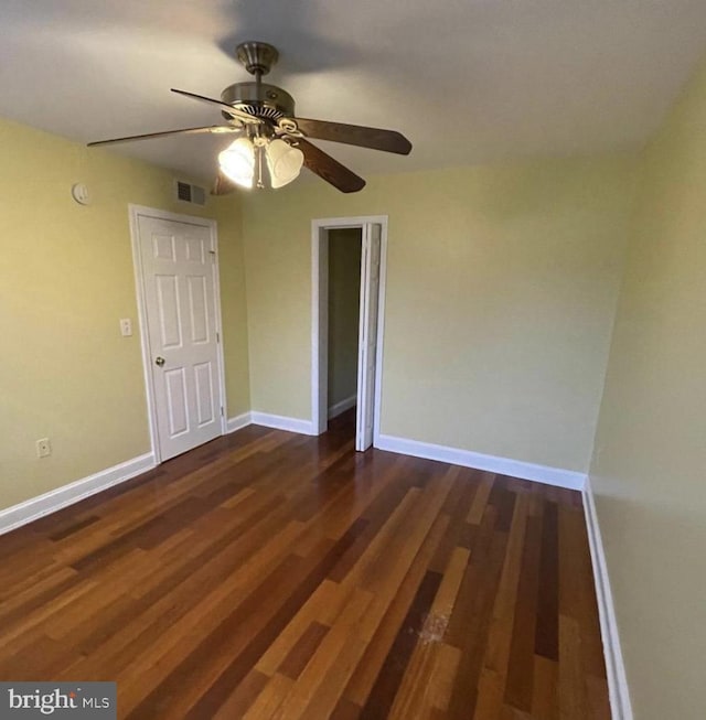 unfurnished bedroom with ceiling fan and dark hardwood / wood-style floors