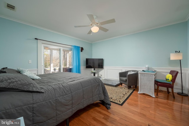 bedroom featuring ornamental molding, light hardwood / wood-style floors, and ceiling fan