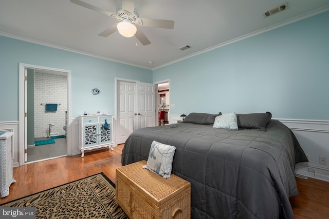 bedroom with hardwood / wood-style floors, ornamental molding, and ceiling fan