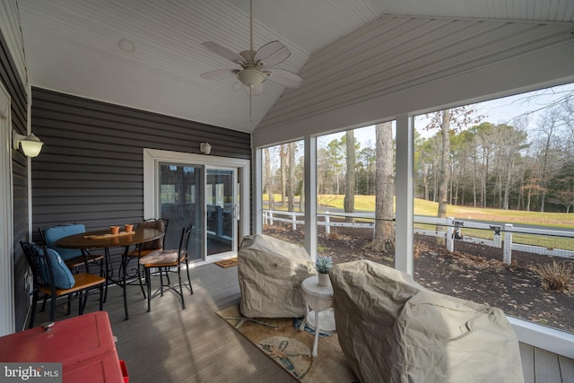 sunroom / solarium featuring lofted ceiling and ceiling fan