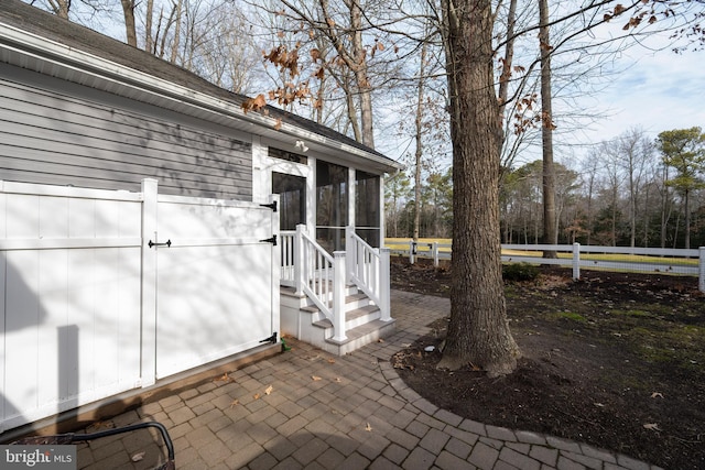 view of exterior entry with a patio