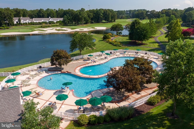 view of swimming pool featuring a yard and a water view