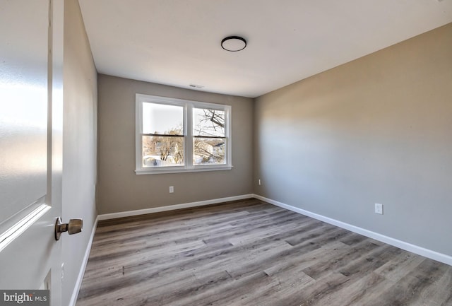 spare room featuring light wood-type flooring