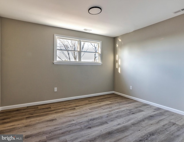 unfurnished room featuring wood-type flooring