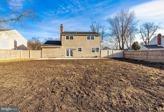 rear view of house with french doors and a patio area