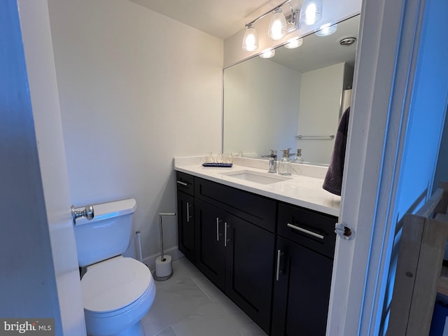 bathroom featuring toilet, marble finish floor, and vanity