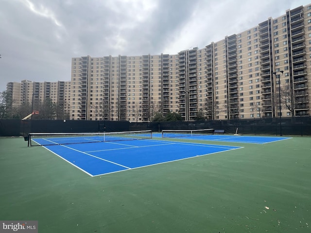 view of sport court featuring fence