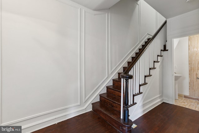 stairway with hardwood / wood-style flooring