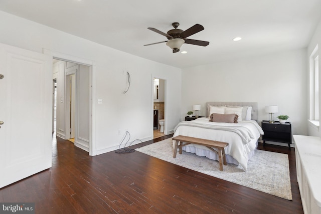 bedroom featuring ceiling fan, dark hardwood / wood-style flooring, and ensuite bath