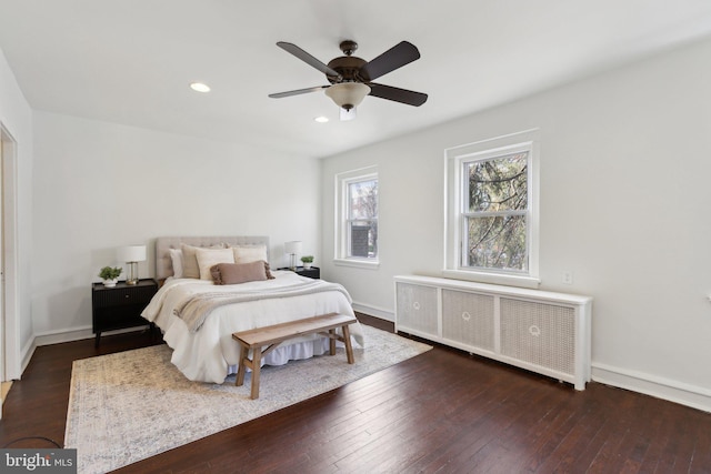 bedroom featuring ceiling fan, radiator, and dark hardwood / wood-style flooring