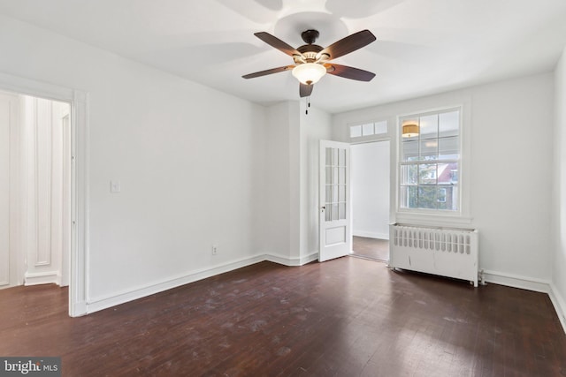 unfurnished bedroom with dark hardwood / wood-style floors, radiator heating unit, and ceiling fan