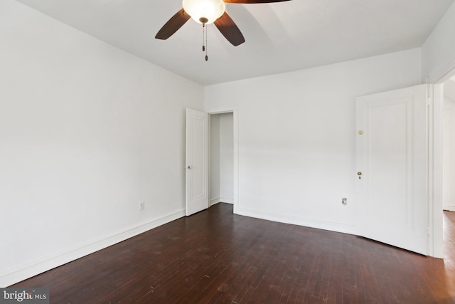 spare room with ceiling fan and dark hardwood / wood-style flooring