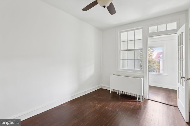 unfurnished room with radiator, dark wood-type flooring, and ceiling fan