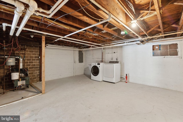 basement featuring electric panel and washer and dryer