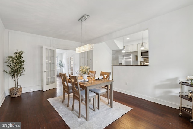 dining space with dark wood-type flooring and french doors