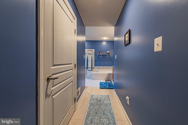 corridor featuring light tile patterned floors