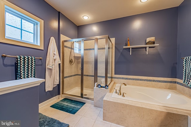 bathroom with shower with separate bathtub and tile patterned floors