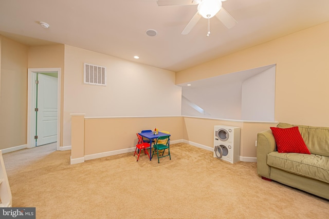 playroom with ceiling fan and light colored carpet