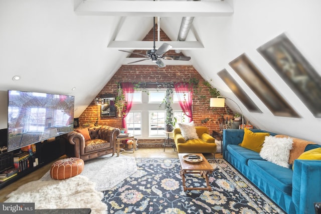 living room with vaulted ceiling with beams, ceiling fan, and brick wall