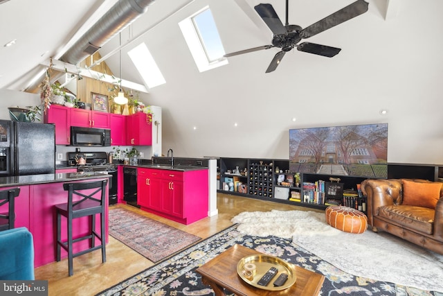 kitchen featuring sink, a breakfast bar area, a center island, a skylight, and black appliances