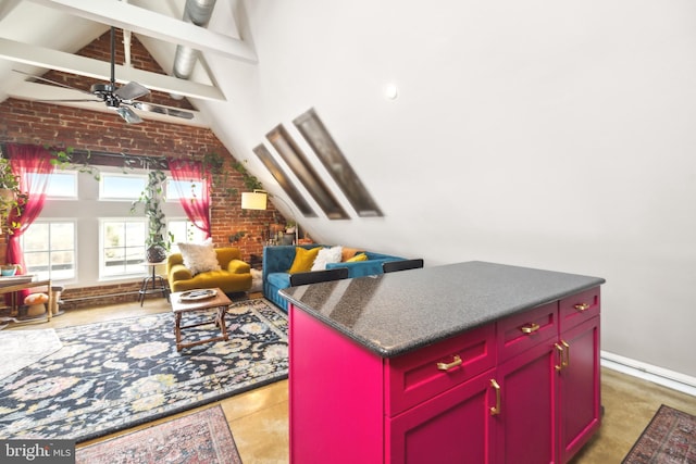 kitchen with a center island, high vaulted ceiling, beamed ceiling, ceiling fan, and brick wall