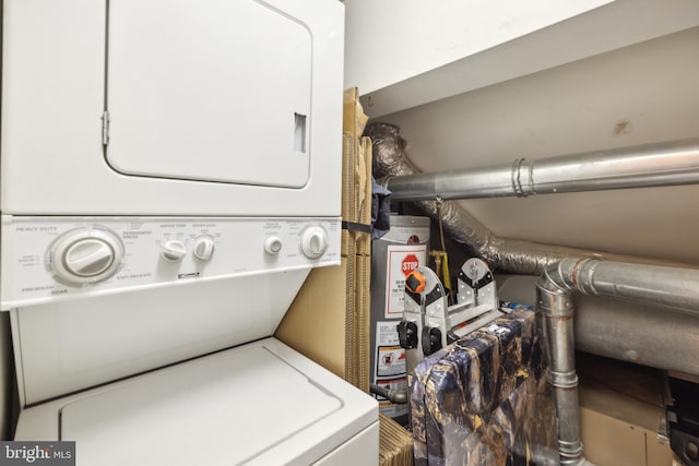 laundry room featuring stacked washer / drying machine