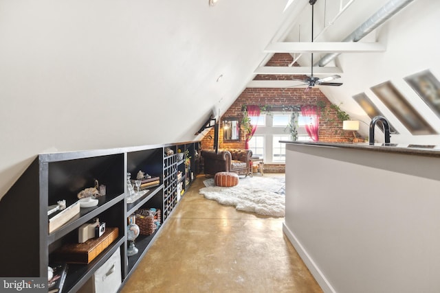 additional living space with sink, vaulted ceiling, concrete floors, and ceiling fan