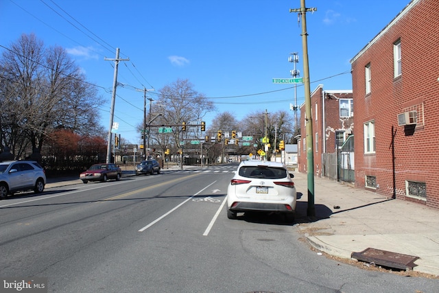 view of street with curbs, traffic lights, and sidewalks