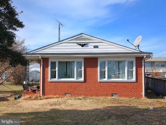 view of side of home featuring a lawn