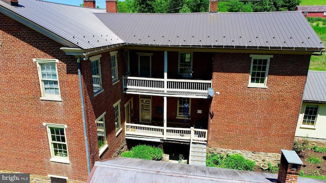 back of house featuring a balcony