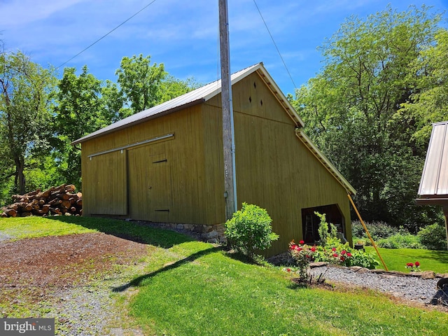 view of outbuilding featuring a yard