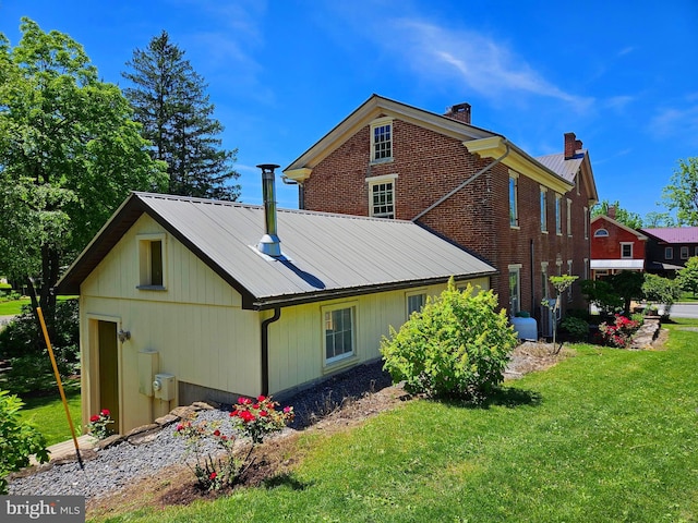 rear view of house with a yard