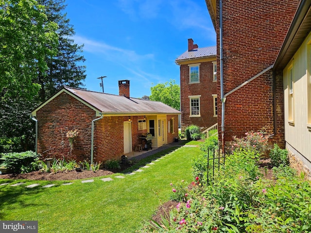 rear view of property with a yard