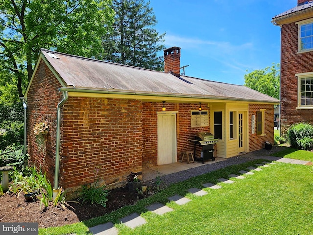 rear view of property with a lawn