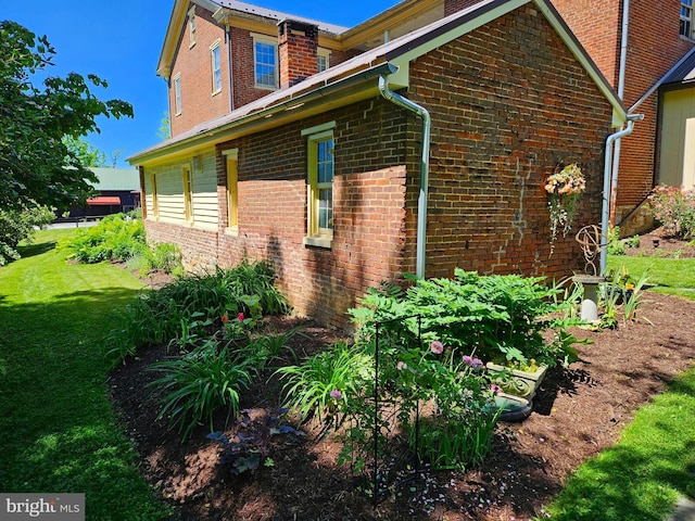 view of home's exterior with a lawn