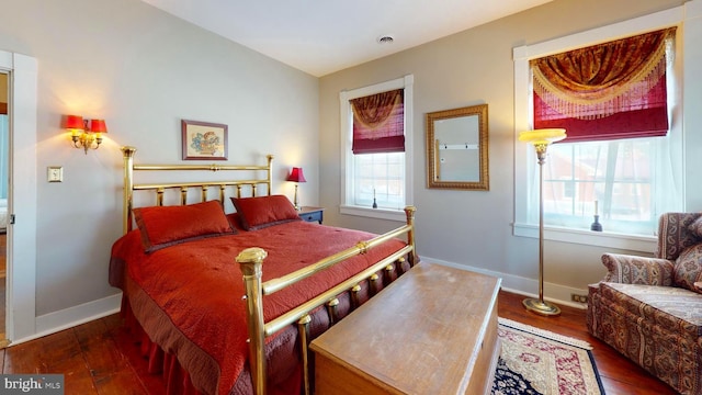 bedroom with dark hardwood / wood-style flooring